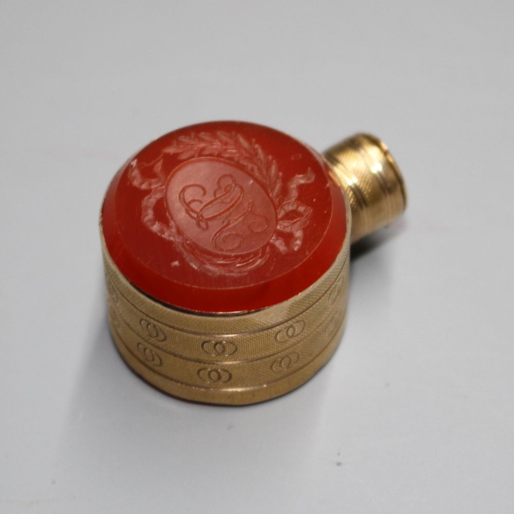 A small 19th century engraved gold and carnelian set moon shaped scent flask,